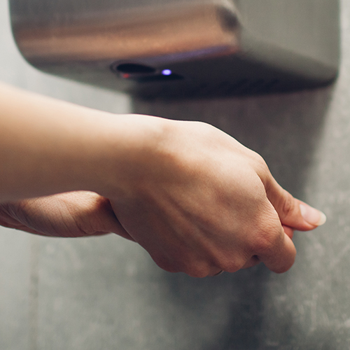 Cleaning hands under a Hand Dryer